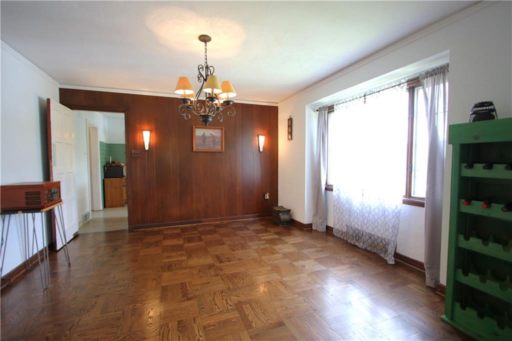 1121 Try Street Monongahela, PA 15063 - Photo 4 of 38 Large Picture Window calls in the Natural Sunlight in this Separate 14x13 Formal Dining Room w/ Original Parquet Wood Floors just refinished in Sept 2023 & Original Chandelier from when the structure was built along w/ Attractive Wall Sconce and swing door into Kitchen