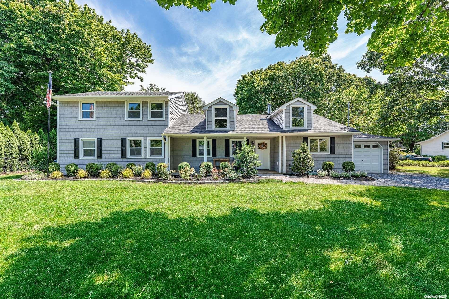 a front view of a house with swimming pool having outdoor seating