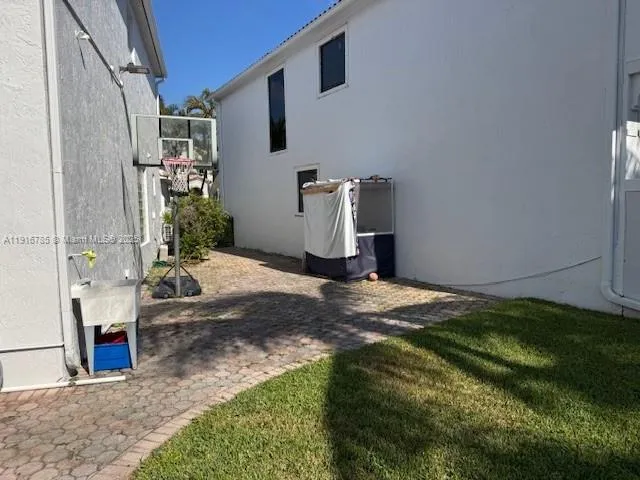 a backyard of a house with table and chairs