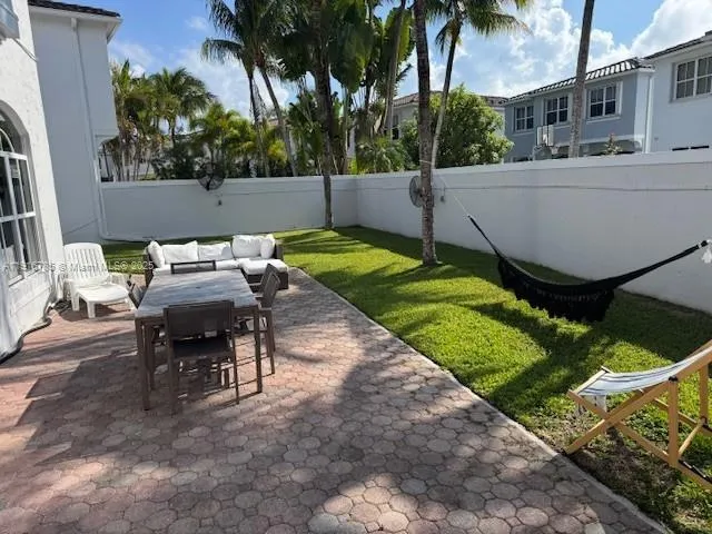 a view of a patio with table and chairs with wooden fence