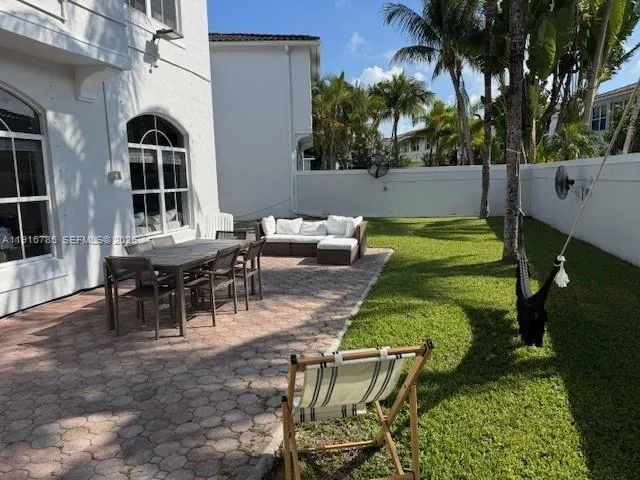 a view of a chairs and table in backyard