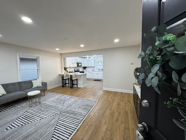 a living room with furniture and a chandelier