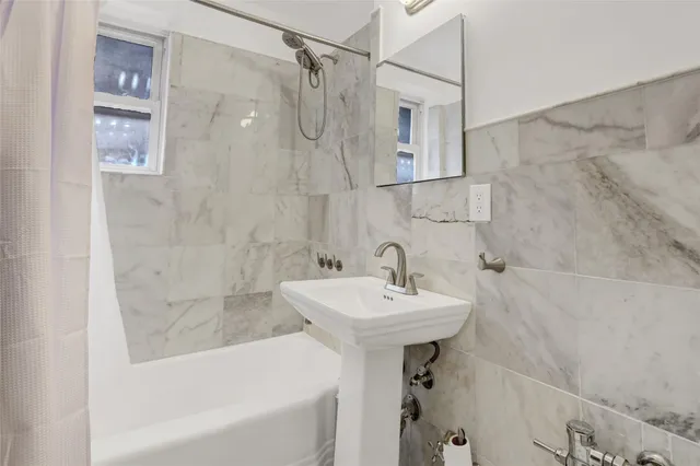 a bathroom with a sink shower and bathtub