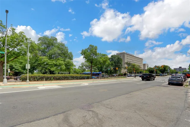 a view of a city street with a parked cars
