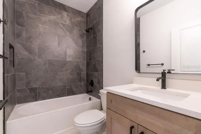 a bathroom with a sink a toilet and a bathtub