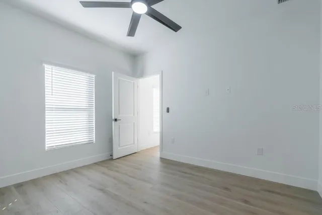wooden floor in an empty room with a window