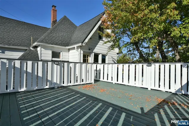 a kitchen with a sink a wooden floor and a large window