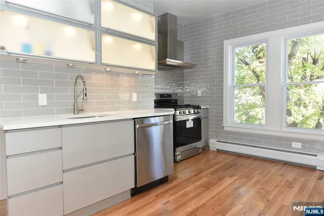 a kitchen with stainless steel appliances granite countertop a stove and a refrigerator