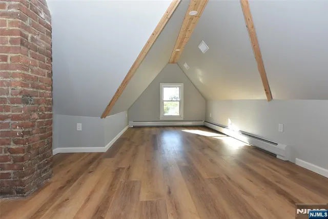 a view of a hallway with wooden floor and stairs