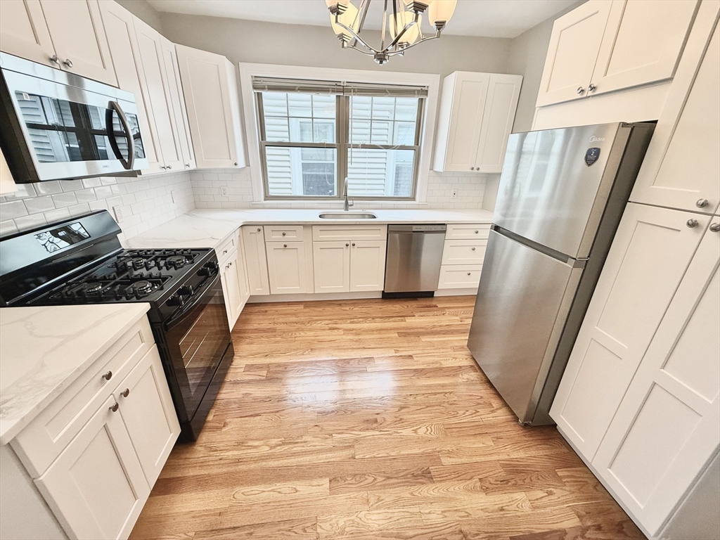 a kitchen with a refrigerator a sink and a stove