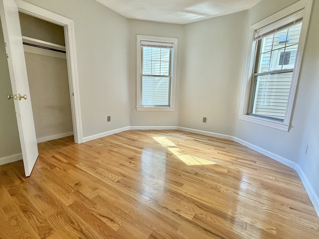 184 Boston Street, Unit 2 Boston, MA 02125 - Photo 8 of 14 a view of empty room with wooden floor and fan