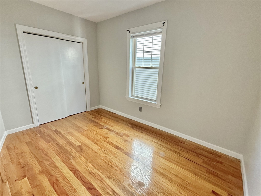 184 Boston Street, Unit 2 Boston, MA 02125 - Photo 10 of 14 a view of empty room with wooden floor and fan