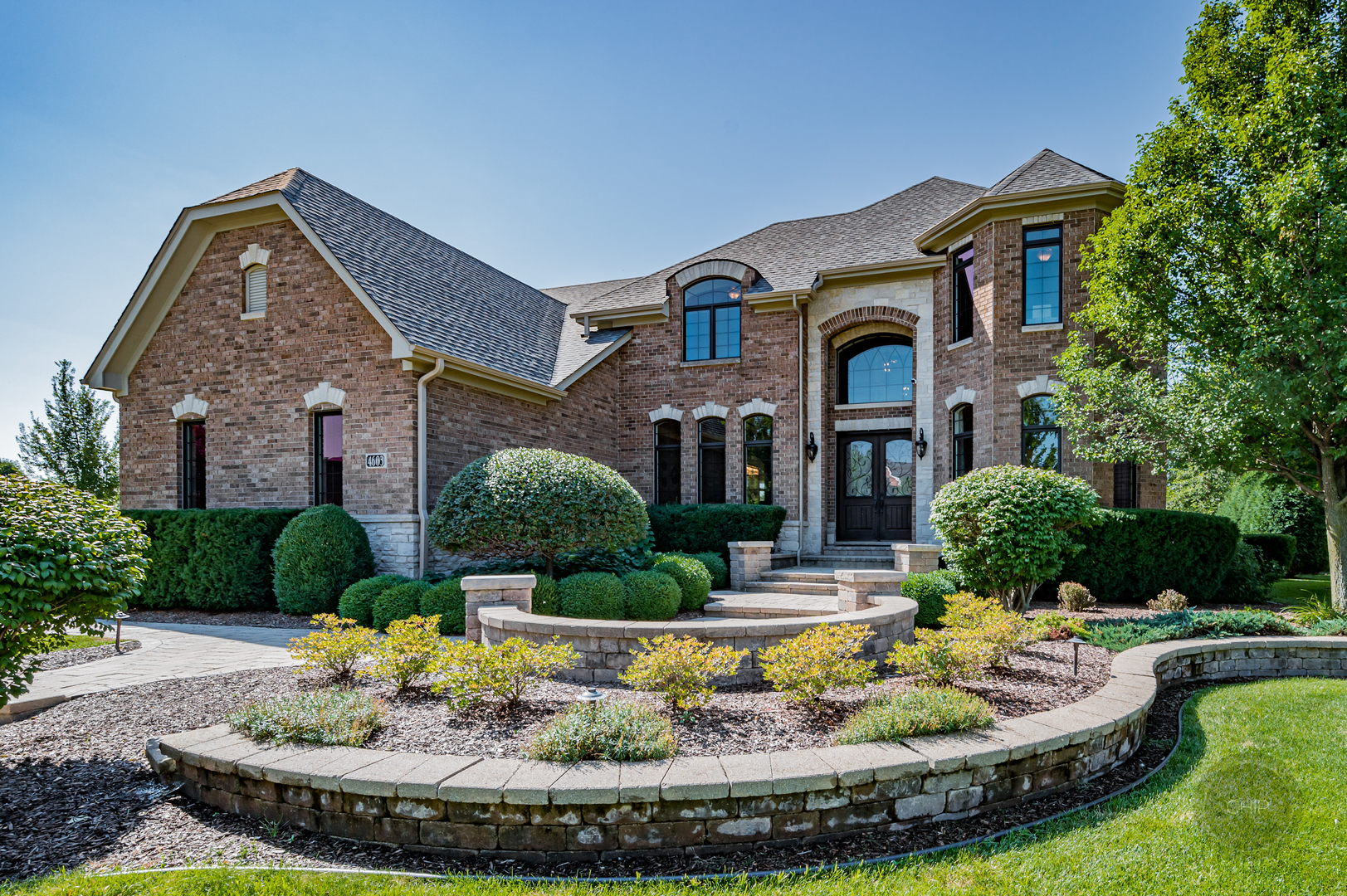4603 Corktree Road Naperville, IL 60564 - Photo 1 of 61 a front view of a house with a yard table and chairs