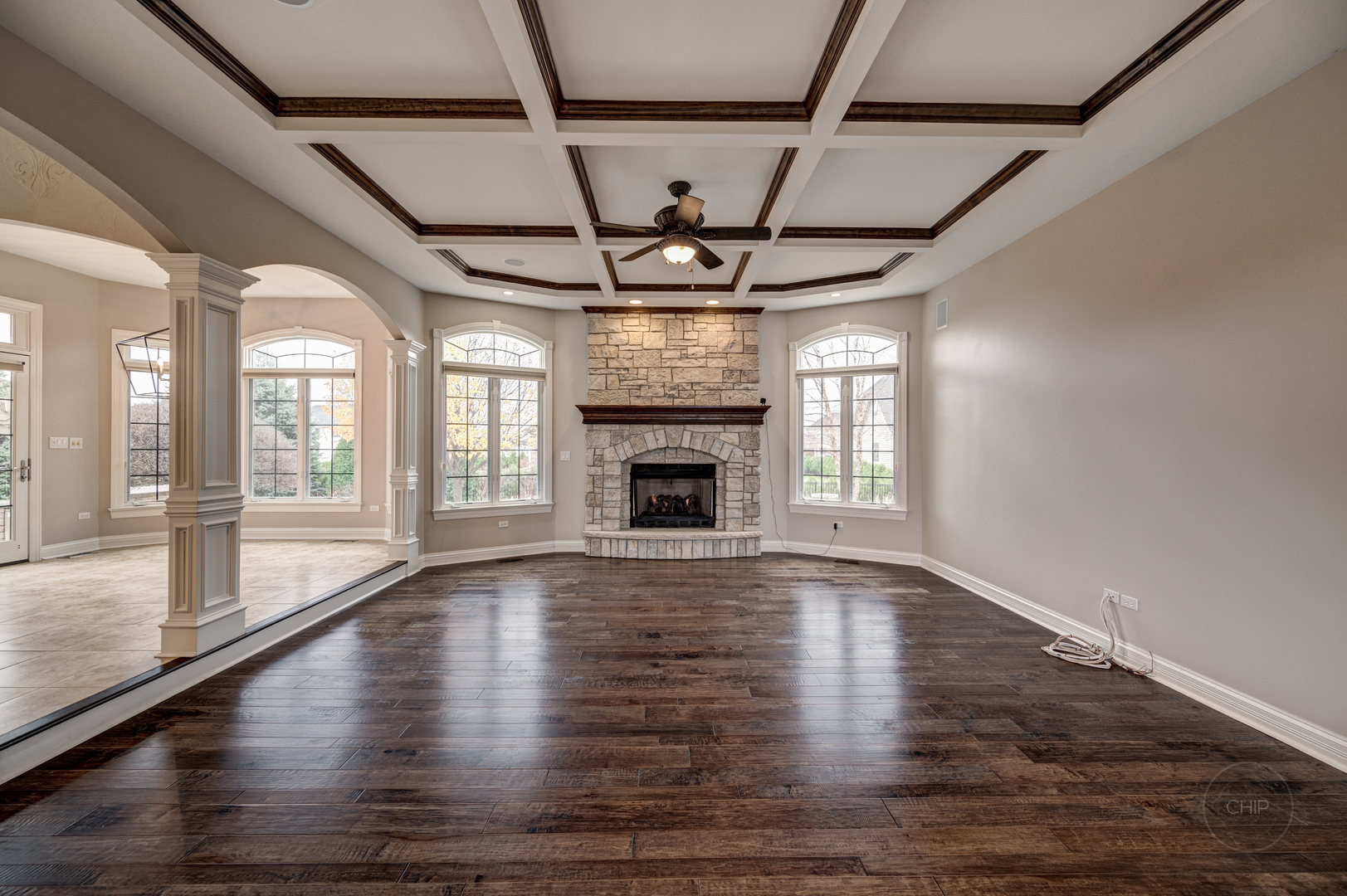 4603 Corktree Road Naperville, IL 60564 - Photo 11 of 61 a view of an empty room with wooden floor fireplace and a window