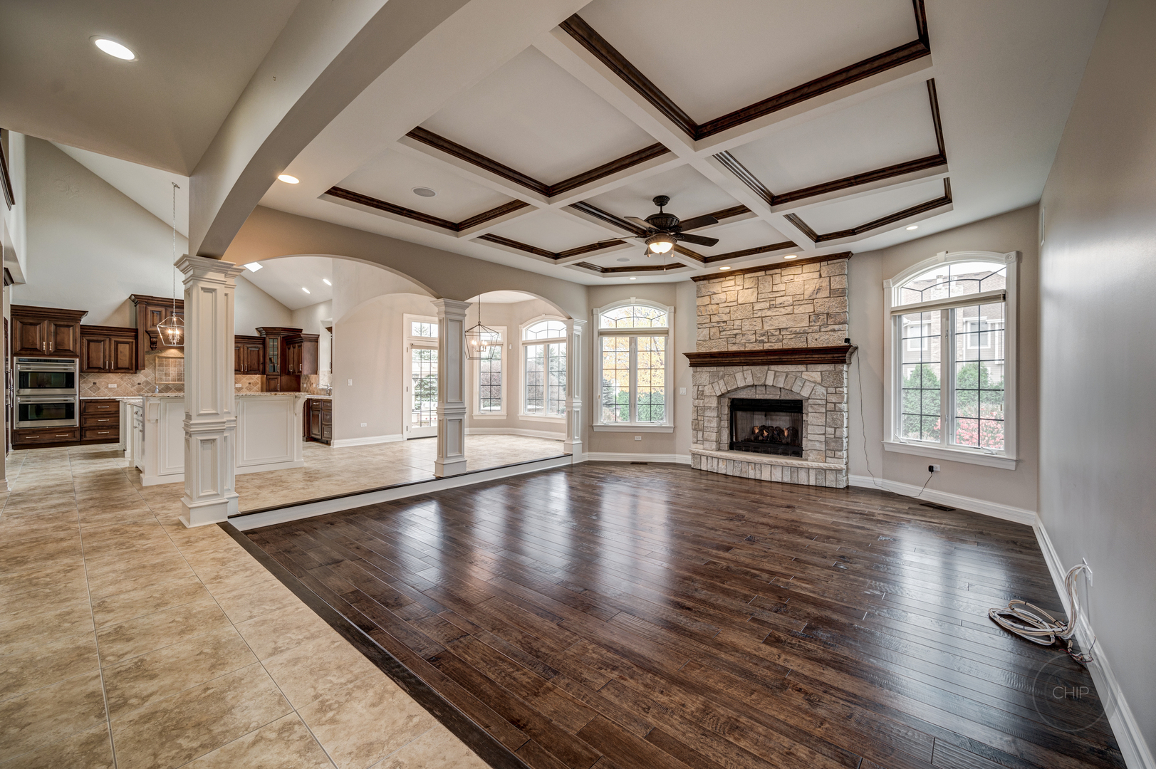 4603 Corktree Road Naperville, IL 60564 - Photo 12 of 61 an empty room with wooden floor and fireplace