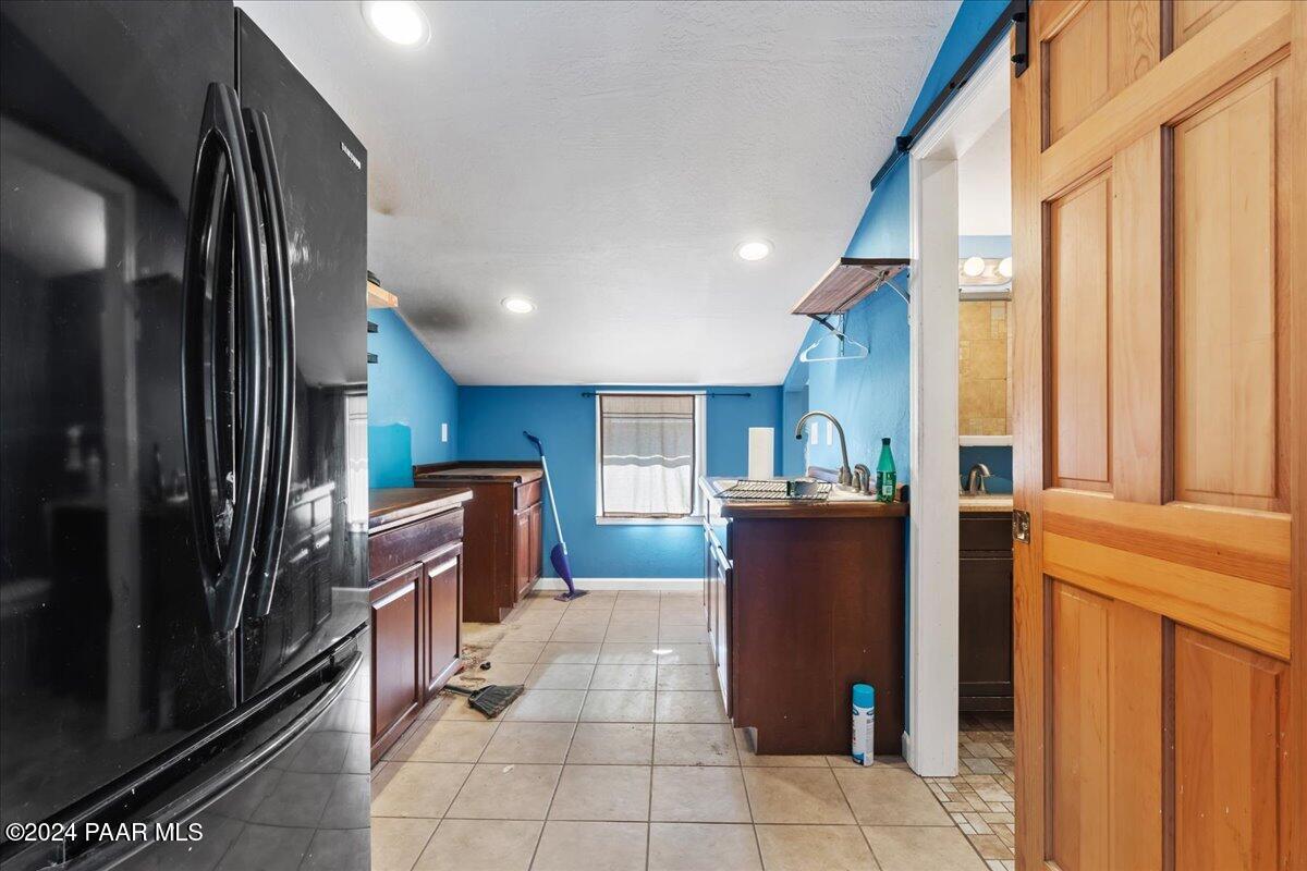 17400 Round Mountain Road Dewey, AZ 86327 - Photo 21 of 25 a kitchen with a refrigerator and a stove