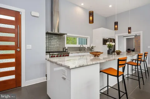 a kitchen with a sink stainless steel appliances and white cabinets