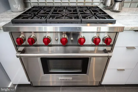 a living room with furniture a dining table and a chandelier