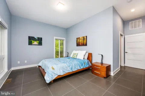 a view of a hallway view with wooden floor and entryway