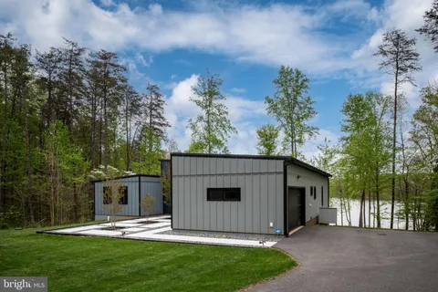 a kitchen with a sink and chairs