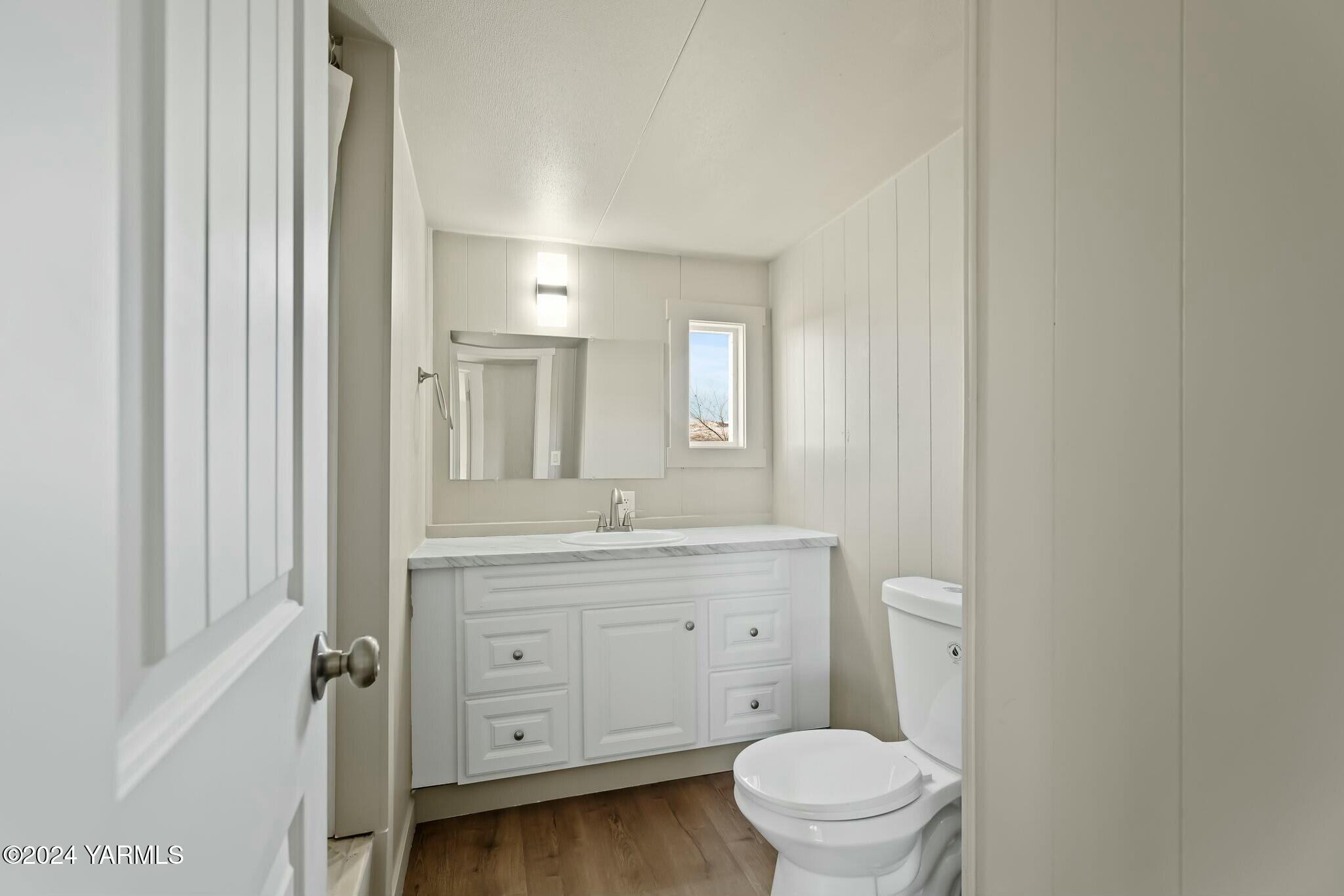 590 Hideaway Road Yakima, WA 98908 - Photo 21 of 34 a bathroom with a toilet a sink a mirror a vanity and window