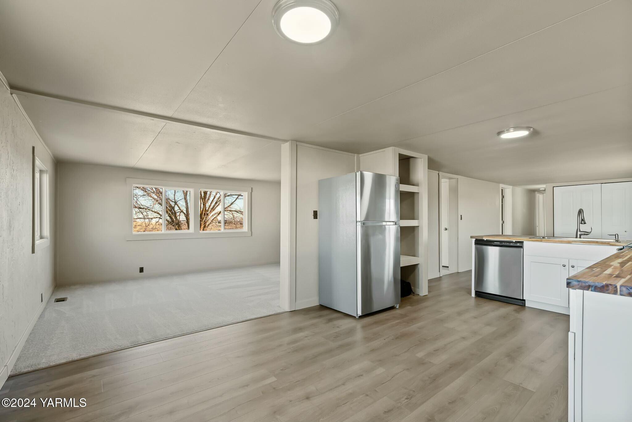 590 Hideaway Road Yakima, WA 98908 - Photo 9 of 34 a view of a kitchen with refrigerator and wooden floor