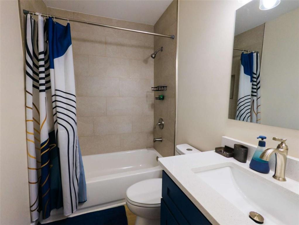 6557 Woodrow Road Lithonia, GA 30038 - Photo 8 of 17 a bathroom with a sink a toilet and a bathtub