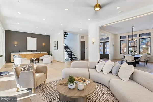 a kitchen with stainless steel appliances granite countertop a table chairs sink and stove