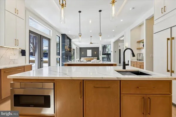a kitchen with granite countertop white cabinets and a sink