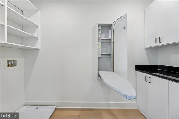 a view of a room with wooden floor and window