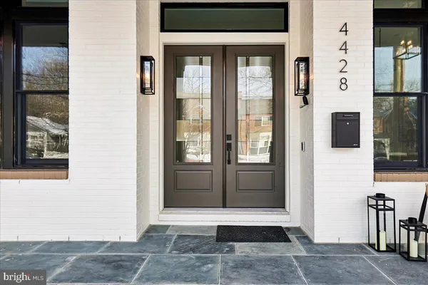 a living room with furniture a potted plant and a large window