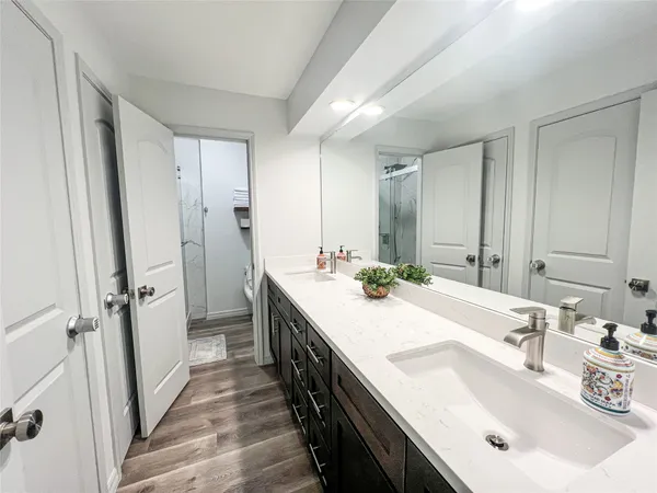 a bathroom with a sink a mirror and a shower