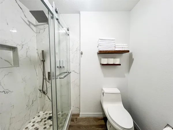 a bathroom with a toilet and a shower