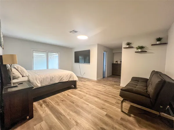 a bedroom with a bed couch and a window
