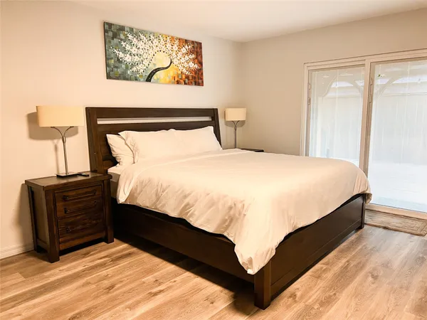 a large bed sitting in a bedroom next to a cabinet
