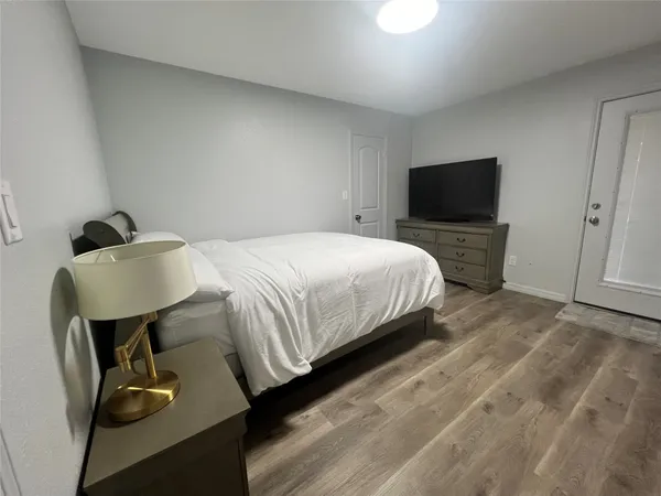 a bedroom with a bed and a television