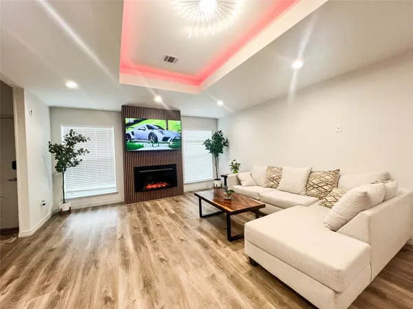 a living room with furniture a fireplace and a potted plant