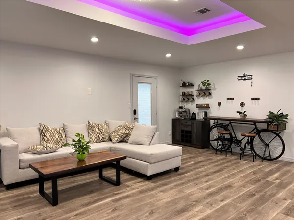 a living room with furniture and wooden floor