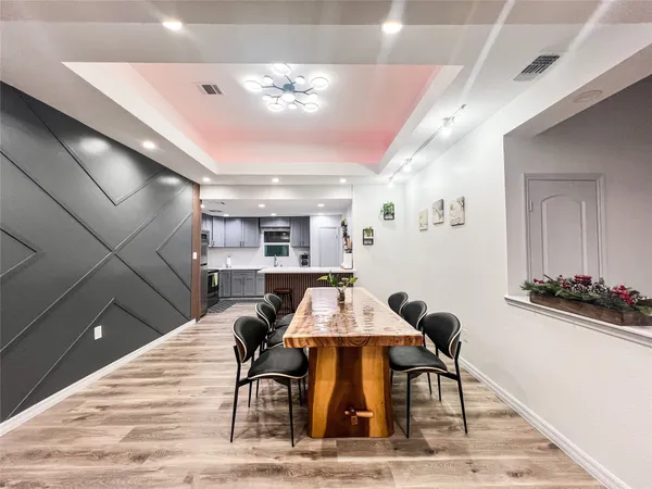 a view of a dining room with furniture and wooden floor