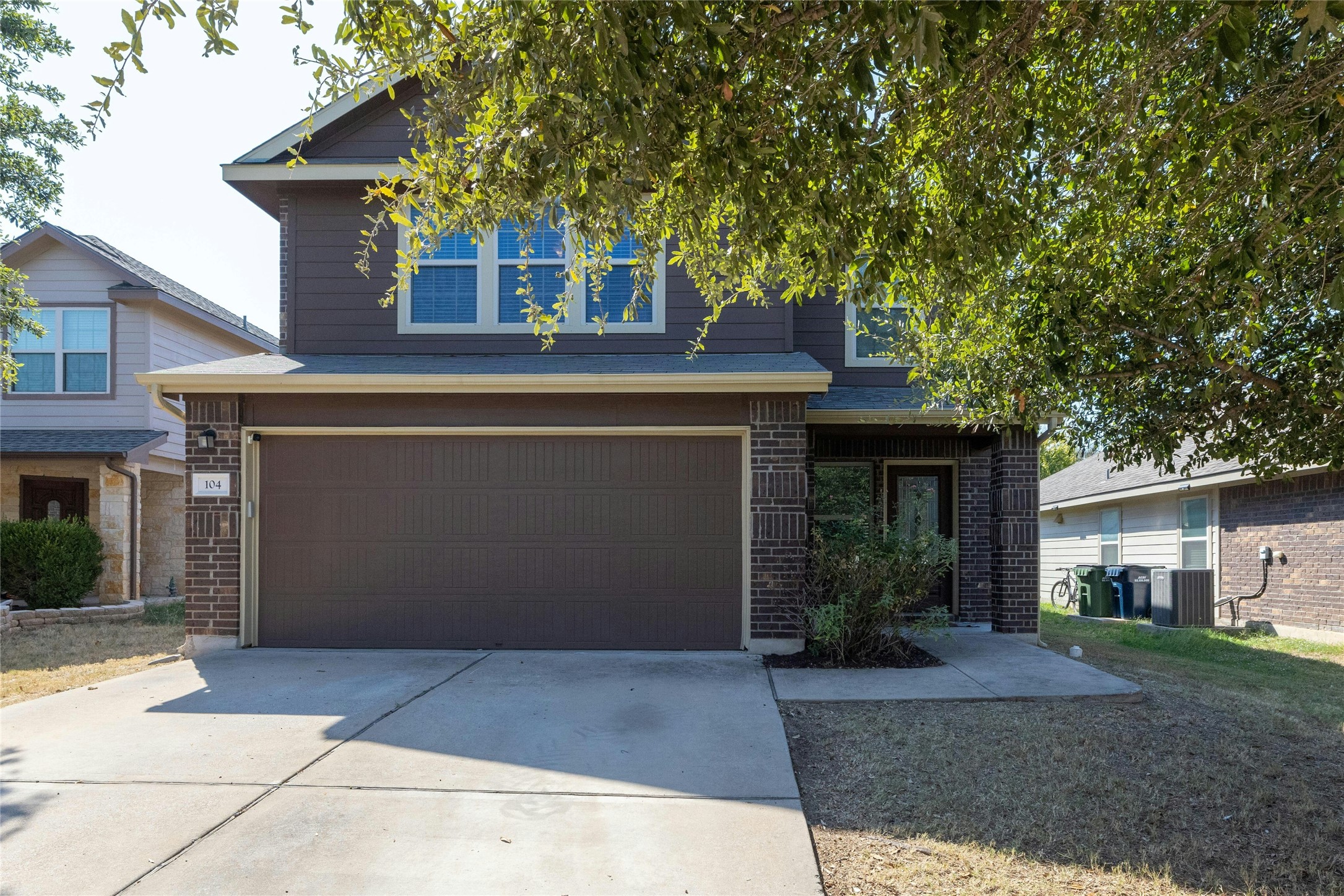 104 Bufflehead Lane Leander, TX 78641 - Photo 1 of 34 View of front of property featuring brick siding, driveway, and an attached garage