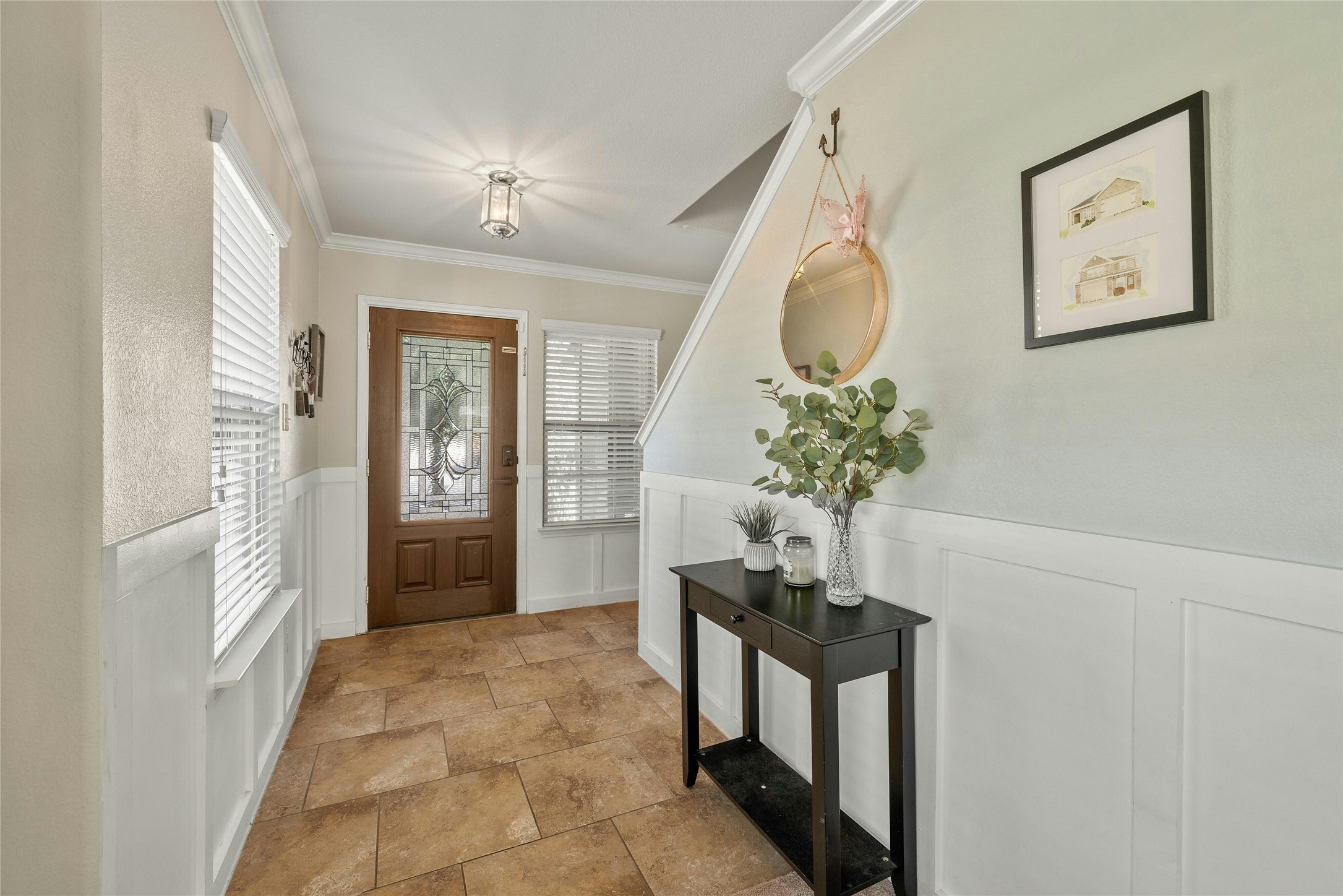 104 Bufflehead Lane Leander, TX 78641 - Photo 13 of 34 Entrance foyer featuring wainscoting, a decorative wall, and crown molding