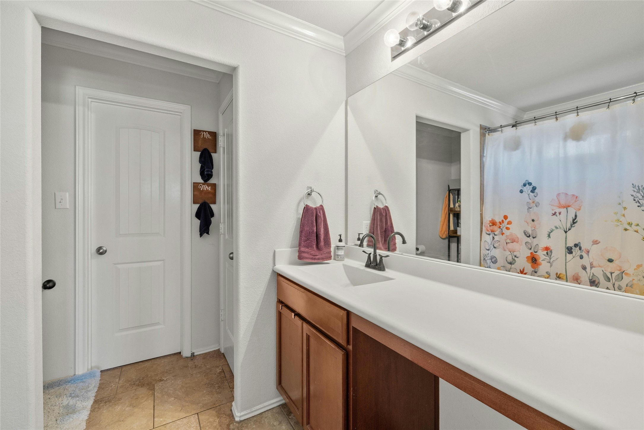 104 Bufflehead Lane Leander, TX 78641 - Photo 17 of 34 Bathroom with vanity, a shower with shower curtain, crown molding, and light tile patterned floors