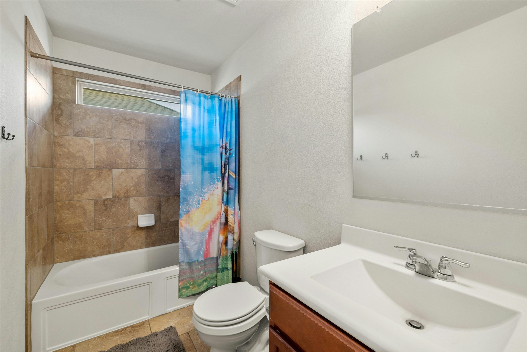 104 Bufflehead Lane Leander, TX 78641 - Photo 21 of 34 Full bath featuring shower / bath combo with shower curtain, vanity, and light tile patterned floors