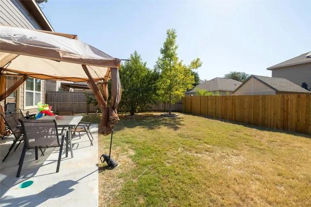 a view of a house with backyard porch and sitting area