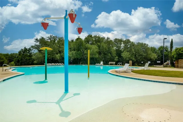 a view of a patio with a table and chairs under an umbrella