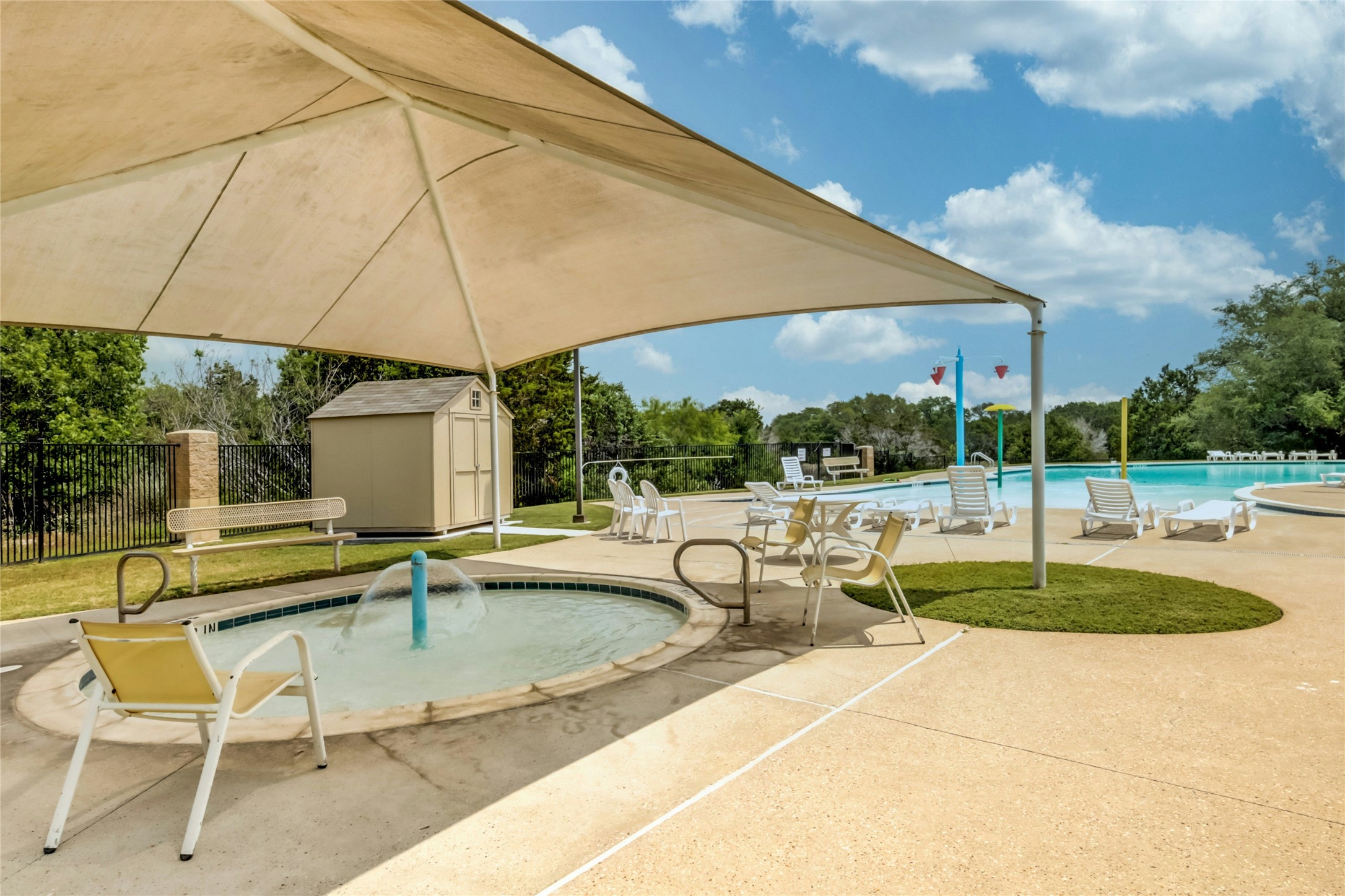 104 Bufflehead Lane Leander, TX 78641 - Photo 31 of 34 Community pool with a storage unit, a patio area, and view of wooded area