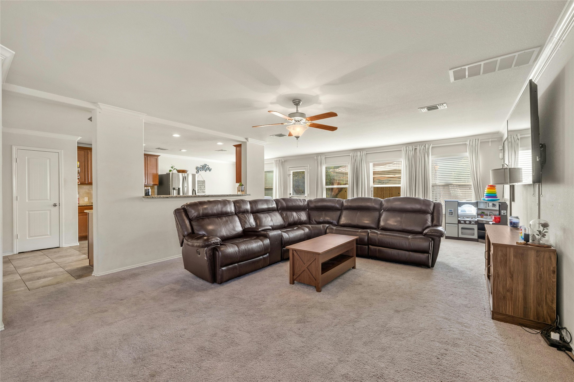 104 Bufflehead Lane Leander, TX 78641 - Photo 4 of 34 Living area featuring light carpet, a ceiling fan, and recessed lighting