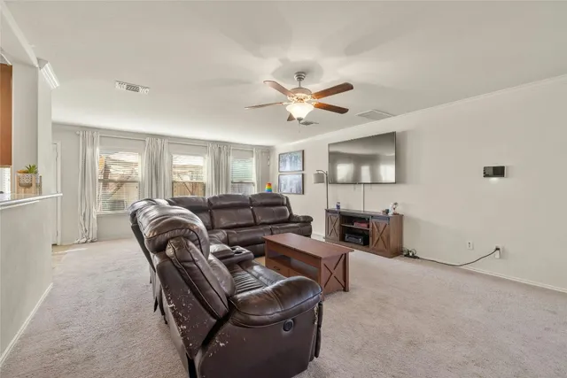 a living room with furniture a fireplace and a window