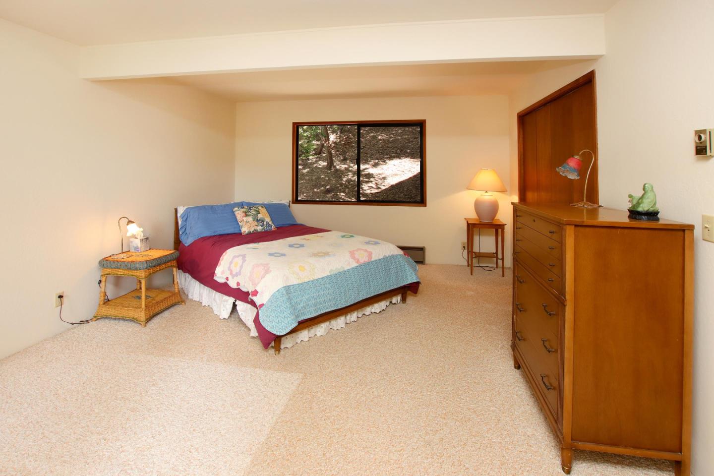 17 Pleasant Heights Drive Aptos, CA 95003 - Photo 19 of 21 a bedroom with a bed and a table in it