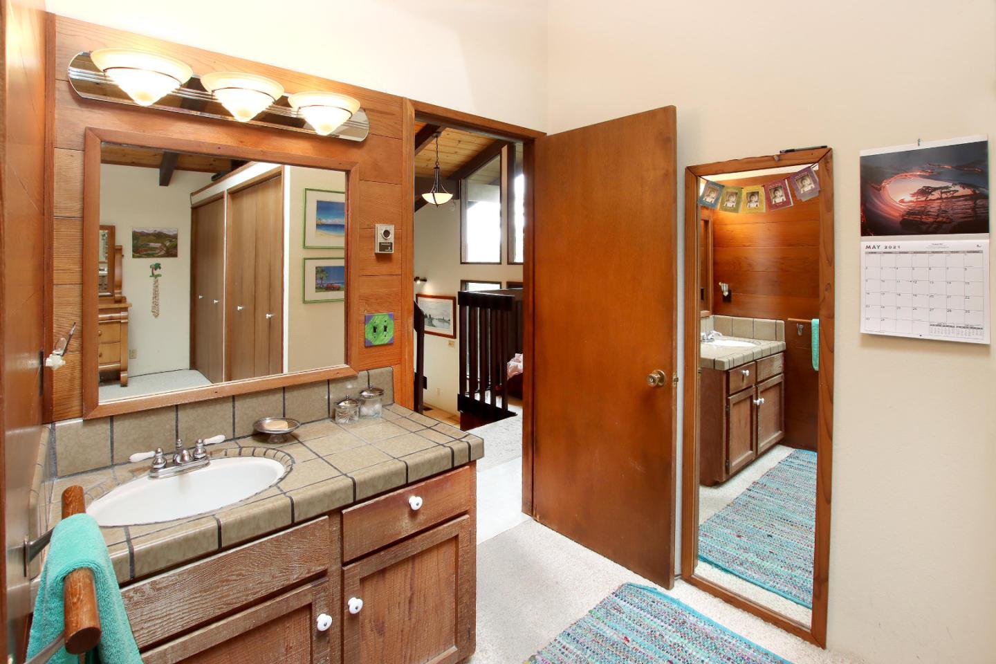 17 Pleasant Heights Drive Aptos, CA 95003 - Photo 9 of 21 a bathroom with a sink a mirror and a shower